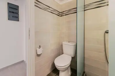 a bathroom with a toilet and a glass shower at Mailo&Luke apartments in Rhodes Town