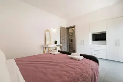 a bedroom with a bed with two towels on it at Mailo&Luke apartments in Rhodes Town
