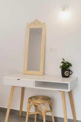 a white desk with a mirror and a stool at Mailo&Luke apartments in Rhodes Town
