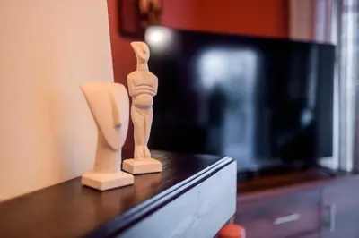 a wooden figurine sitting on a table next to a tv at Villa Eleni in Soroni
