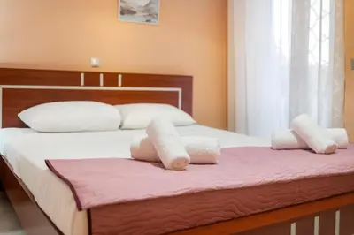 a bedroom with a bed with white towels on it at Villa Eleni in Soroni