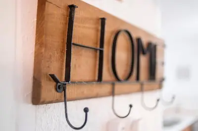 a row of wooden signs hanging on a wall at Villa Eleni in Soroni