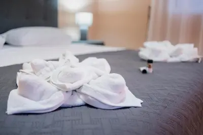 a pile of towels on top of a bed at Villa Eleni in Soroni