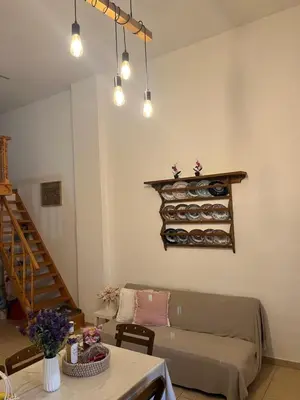 a living room with a couch and a table at Irene’s house in Koskinou