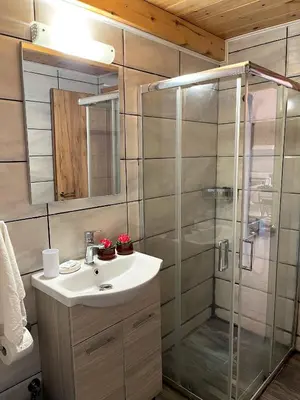 a bathroom with a sink and a shower at Irene’s house in Koskinou