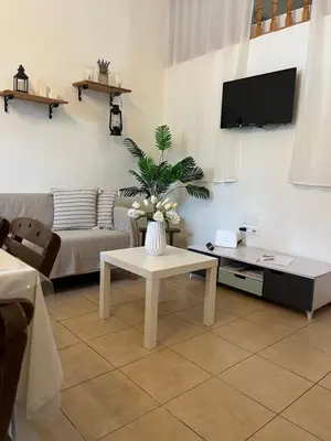 a living room with a couch and a table at Irene’s house in Koskinou