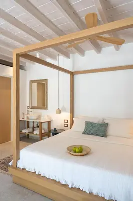 a bedroom with a bed with a bowl of fruit on it at Nisomar Suites in Symi