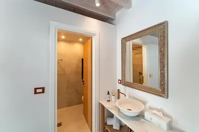 a bathroom with a sink and a mirror at Nisomar Suites in Symi