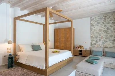a bedroom with a canopy bed in a room at Nisomar Suites in Symi