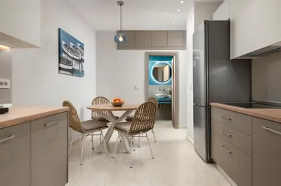 a kitchen and dining room with a table and chairs at Stylish Rhodes Apartment with Prime Location - L & C City Escape in Rhodes Town