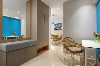 a living room with a table and chairs in a room at Stylish Rhodes Apartment with Prime Location - L & C City Escape in Rhodes Town