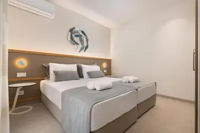 a bedroom with a large bed with towels on it at Stylish Rhodes Apartment with Prime Location - L & C City Escape in Rhodes Town