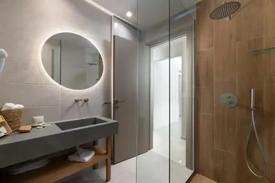 a bathroom with a sink and a shower at Stylish Rhodes Apartment with Prime Location - L & C City Escape in Rhodes Town