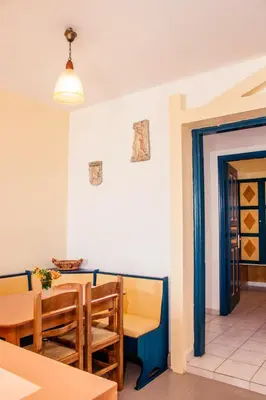a dining room with a table and chairs at Limanaki Seafront Apartments in Faliraki