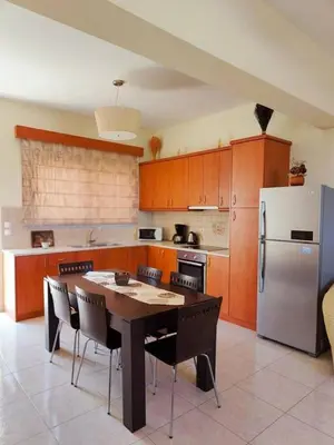 a kitchen with a table and a refrigerator at Bellavista House in Monolithos Rhodes in Monólithos