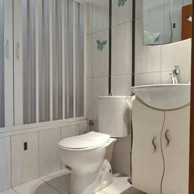 a bathroom with a white toilet and a sink at Bellavista House in Monolithos Rhodes in Monólithos