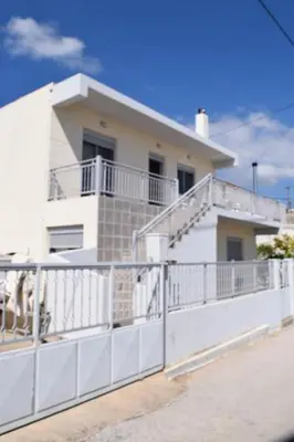 a white house with a fence in front of it at Bellavista House in Monolithos Rhodes in Monólithos