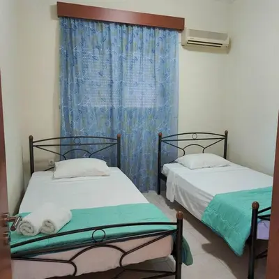 two beds in a room with a window at Bellavista House in Monolithos Rhodes in Monólithos