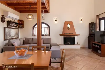 a living room with a table and a couch at Ospition Villa in Apolakkiá