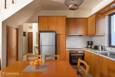 a kitchen with a table with a bowl of fruit on it at Ospition Villa in Apolakkiá
