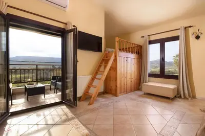 a room with a staircase and a balcony with a view at Ospition Villa in Apolakkiá