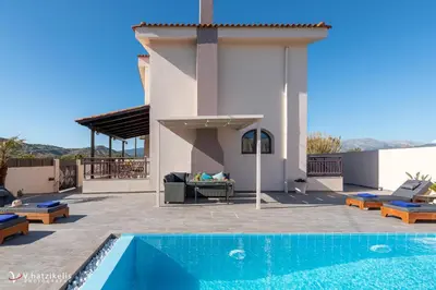 a villa with a swimming pool and a house at Ospition Villa in Apolakkiá