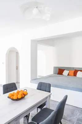 a bedroom with a bed and a table with oranges on it at Kastrena House in Asklipiḯon