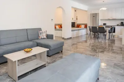a living room with a couch and a table at Kastrena House in Asklipiḯon