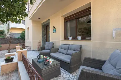 a patio with wicker chairs and a table at Parko Studios in Rhodes Town