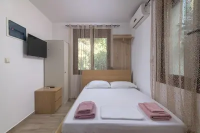 a bedroom with a bed with two towels on it at Parko Studios in Rhodes Town