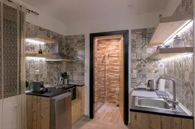 a kitchen with a sink and a refrigerator at Parko Studios in Rhodes Town