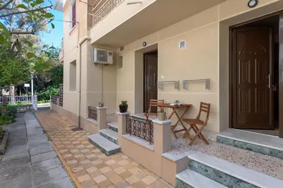 a balcony of a house with a table and a door at Parko Studios in Rhodes Town