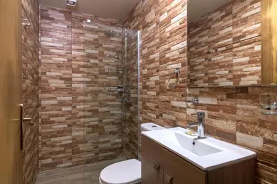 a bathroom with a toilet and a sink and a shower at Parko Studios in Rhodes Town