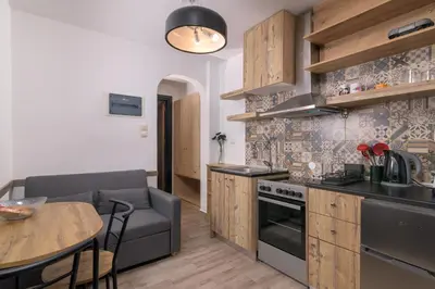 a kitchen with a couch and a table in a room at Parko Studios in Rhodes Town