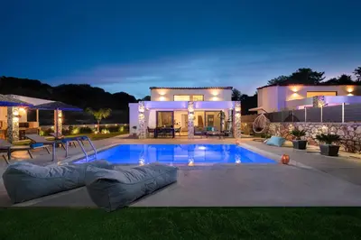 a house with a swimming pool in front of a house at Aiora Luxury Villas in Afantou