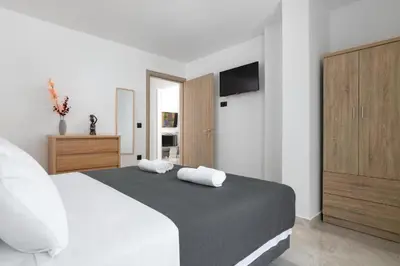 a bedroom with a bed with two towels on it at Aiora Luxury Villas in Afantou