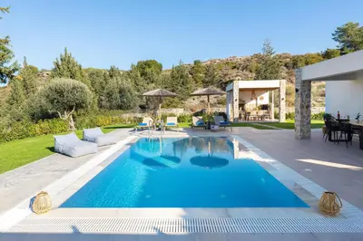 a swimming pool in the middle of a yard at Aiora Luxury Villas in Afantou