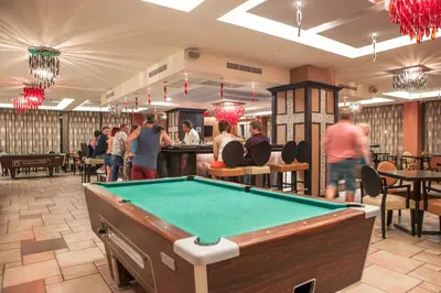 a pool table in a room with a bar at IALYSSOS BAY HOTEL in Ialyssos