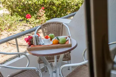 a tray of fruit on a table on a balcony at IALYSSOS BAY HOTEL in Ialyssos