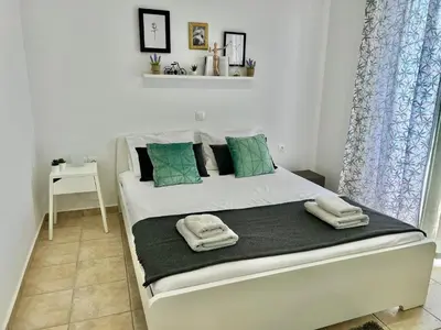 a bedroom with a bed with towels on it at Cute & sweet home in Archangelos