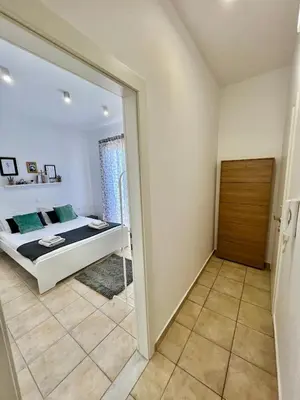 a bedroom with a bed and a sliding glass door at Cute & sweet home in Archangelos