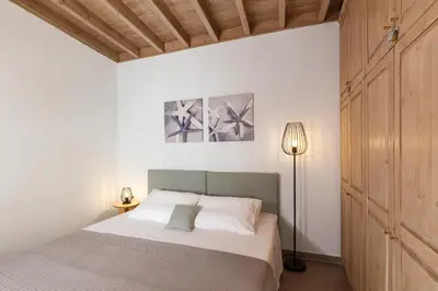 a bedroom with a bed and a floor lamp at LindosaquaView Luxury villa in Líndos