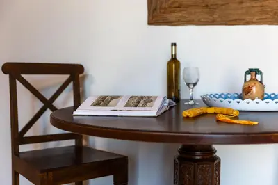 a table with a book and a glass of wine at LindosaquaView Luxury villa in Líndos