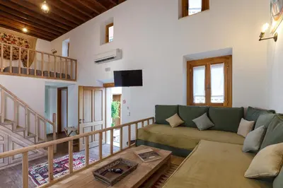 a living room with a couch and a table at LindosaquaView Luxury villa in Líndos