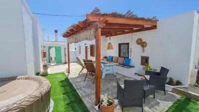a patio with a table and chairs and a pergola at Lefko House in Lachania
