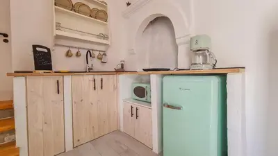 a kitchen with a refrigerator and a microwave at Lefko House in Lachania