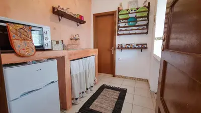 a kitchen with a microwave on a counter and a door at Lefko House in Lachania