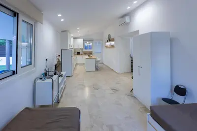 a kitchen with white appliances and a large room at Katerlove Beach House in Faliraki