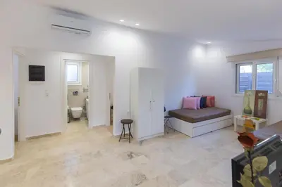 a white room with a bed and a toilet at Katerlove Beach House in Faliraki