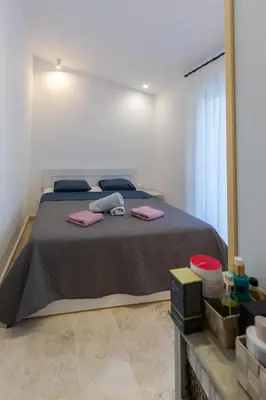 a bedroom with a large bed with pink towels on it at Katerlove Beach House in Faliraki